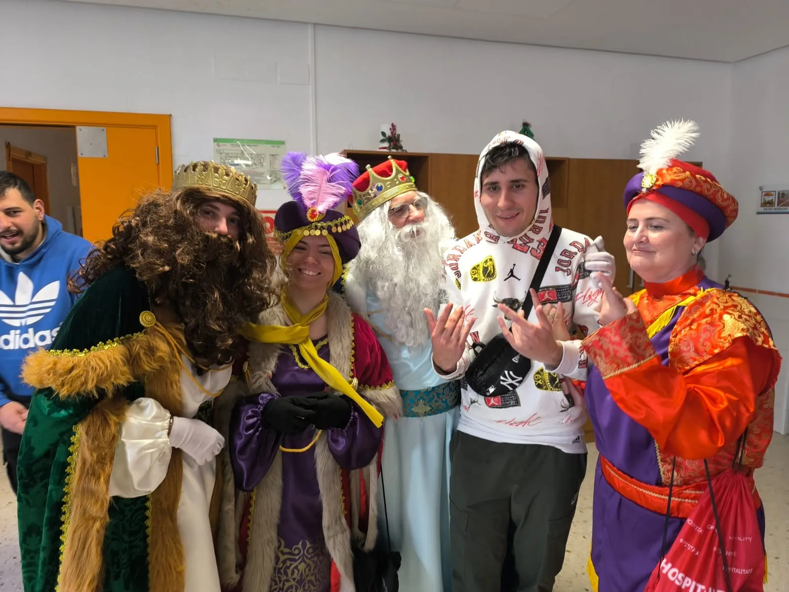 personas voluntarias de la Fundación Hospitalarias Málaga vestigas de Reyes Mago junto a un usuario