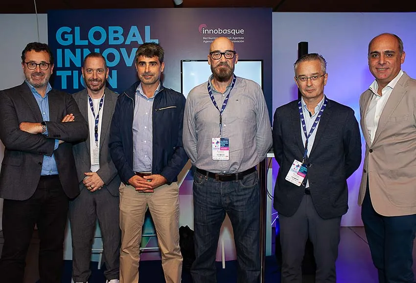 Cinco hombres posan delanta de un panel con el texto Global Innovation Day